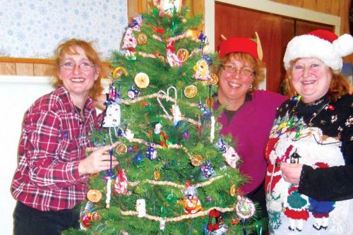 Joanne, Chrissy and Angie decorated Mike Dean's large tree, which won first place at the festival